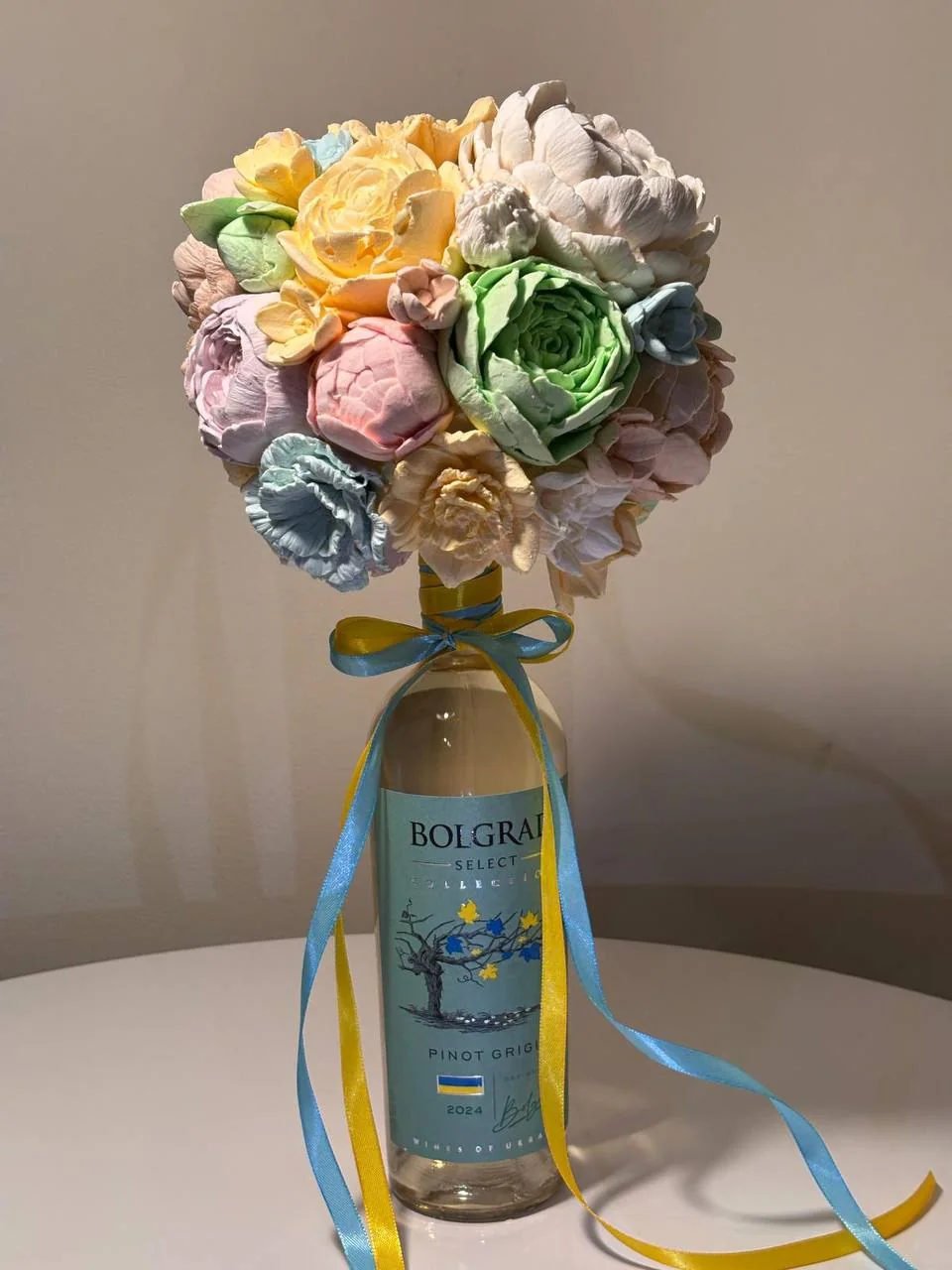 Marshmallow flowers arranged around a celebratory bottle